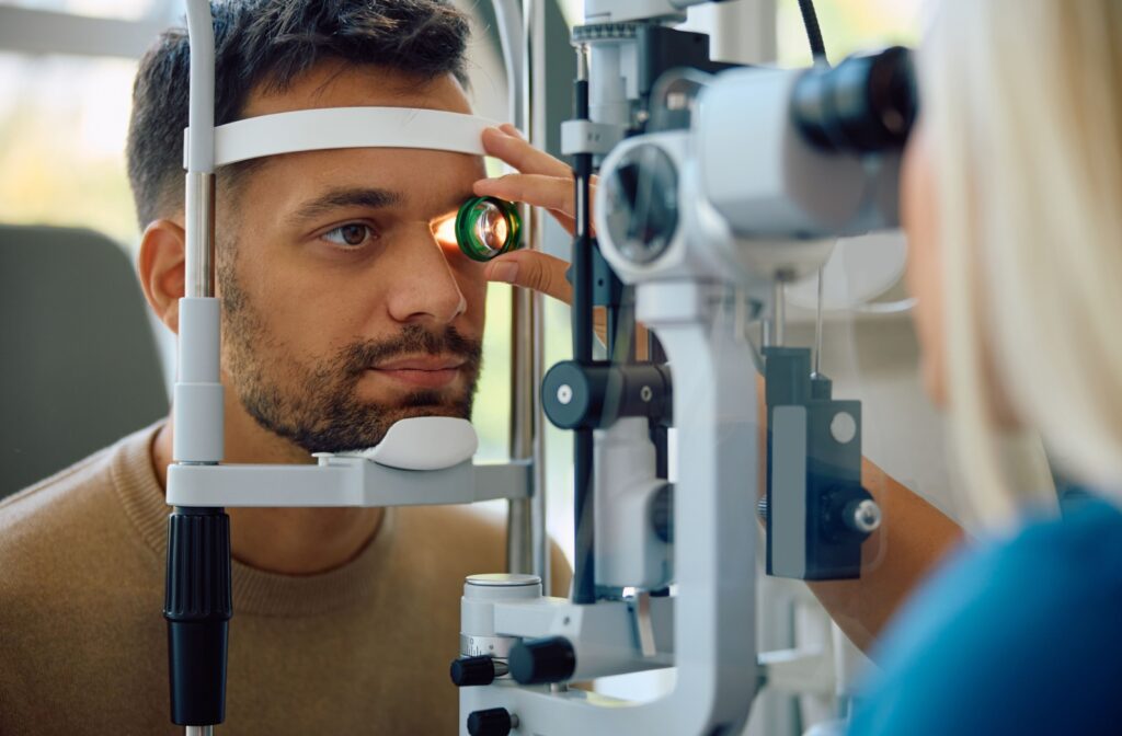 A patient at their eye doctor getting a slit lamp exam as part of their annual eye exam