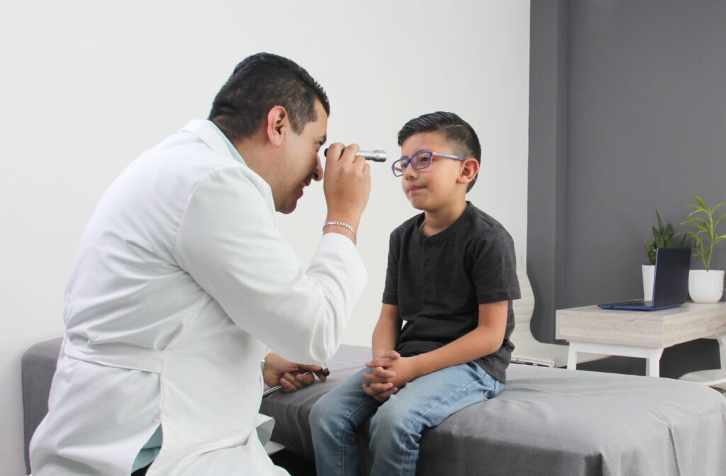 A child getting their eyes looked at by an optometrist at their annual eye exam