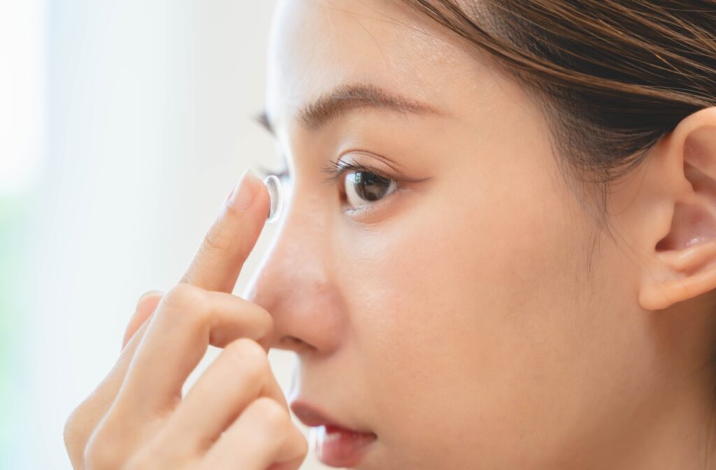 a person placing contact lenses in their eye