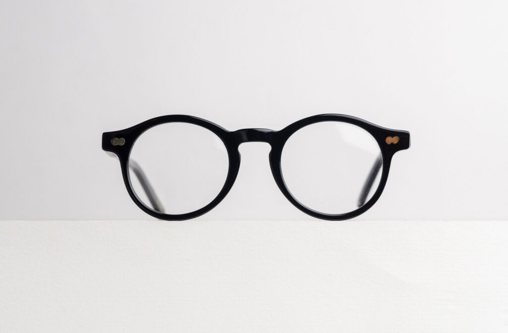 a pair of glasses with black frames on a white background.