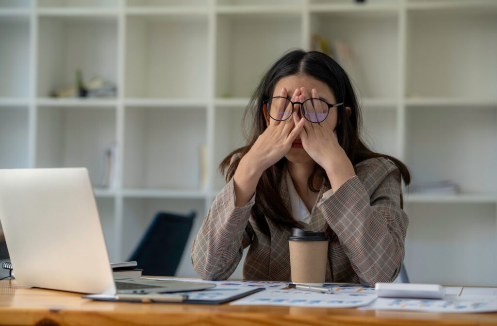 a person rubbing their eyes due to stress