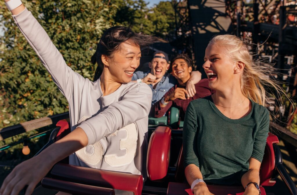 Two friends riding a rollercoaster wearing contact lenses.