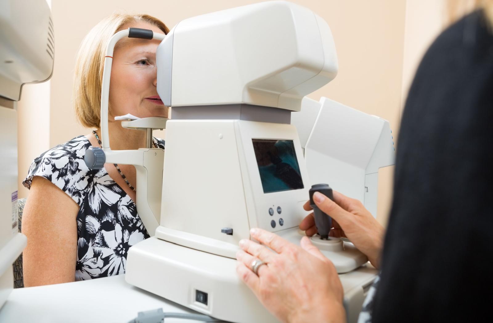 A patient at their optometrist's office, having their eyes tested for signs of cataracts and glaucoma.
